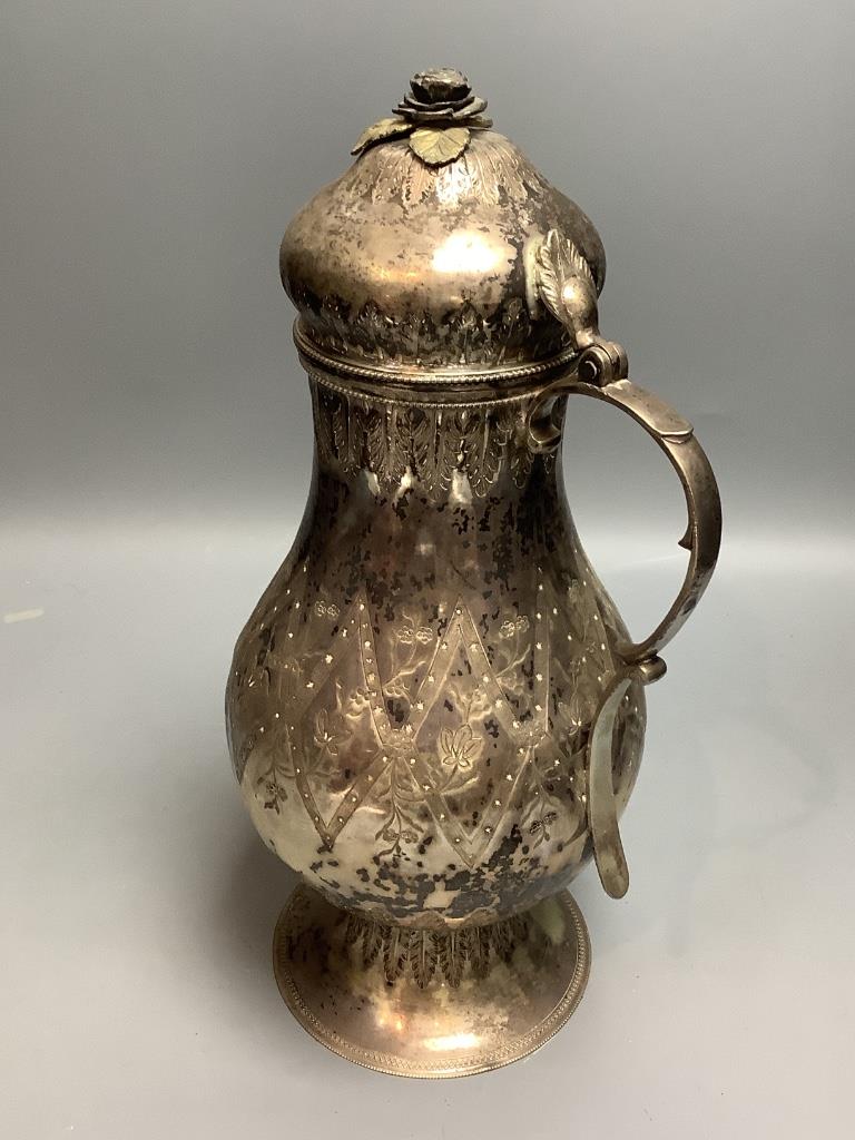 A Persian engraved white metal baluster flagon